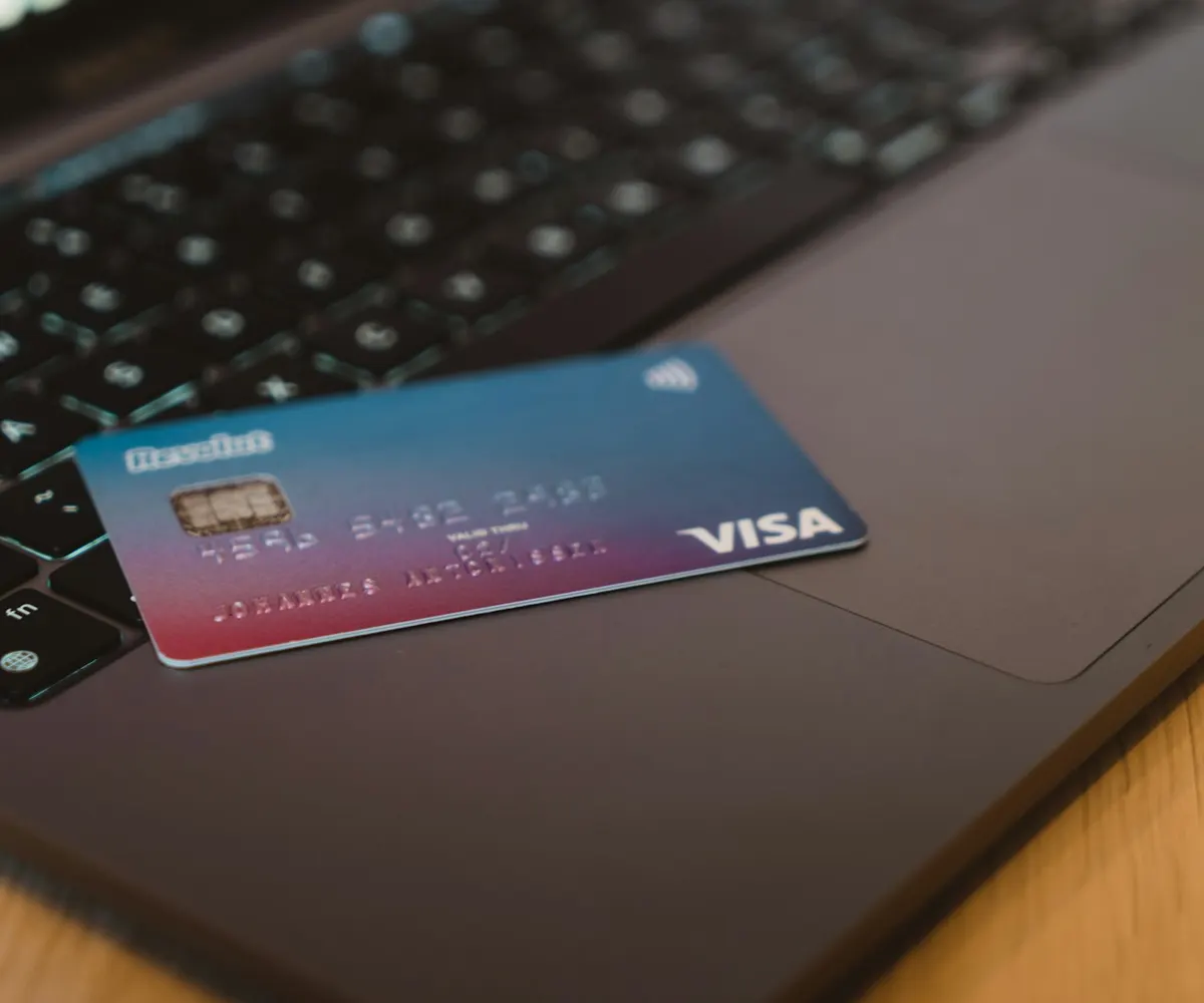 A payment card resting on a laptop keyboard.