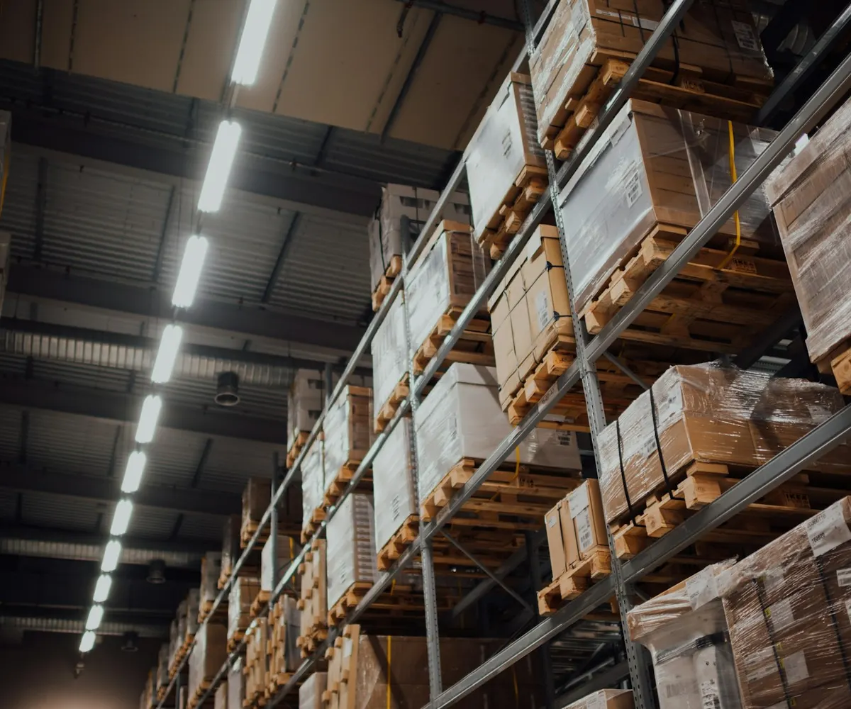 Cardboard cartons stacked on warehouse shelving.